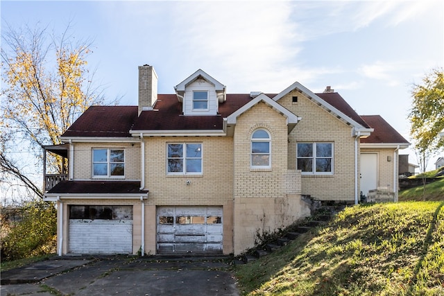 rear view of property with a garage