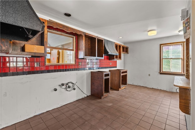 kitchen with ventilation hood, wall chimney range hood, and backsplash