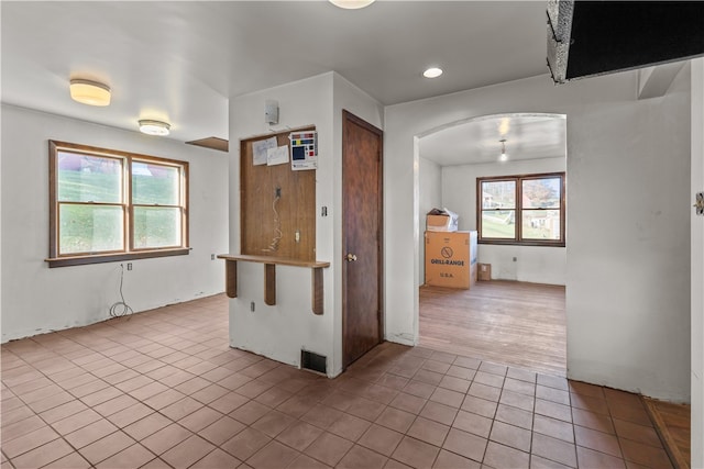 kitchen featuring a breakfast bar area, plenty of natural light, and light hardwood / wood-style flooring