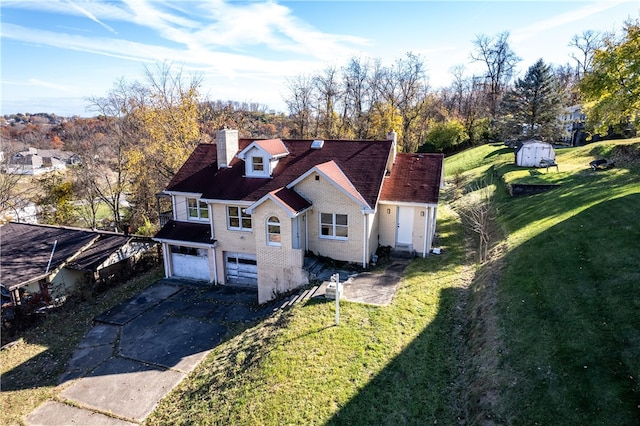 view of front of property with a garage and a front yard