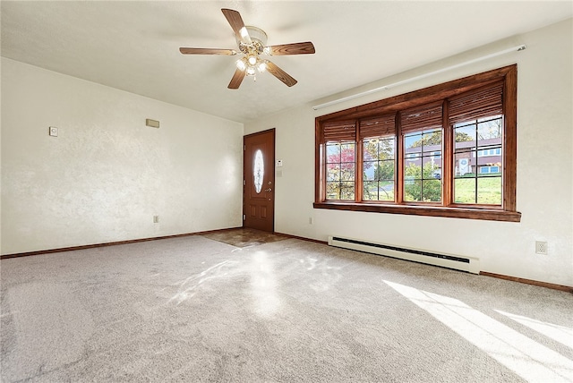 interior space featuring carpet flooring, ceiling fan, and a baseboard heating unit