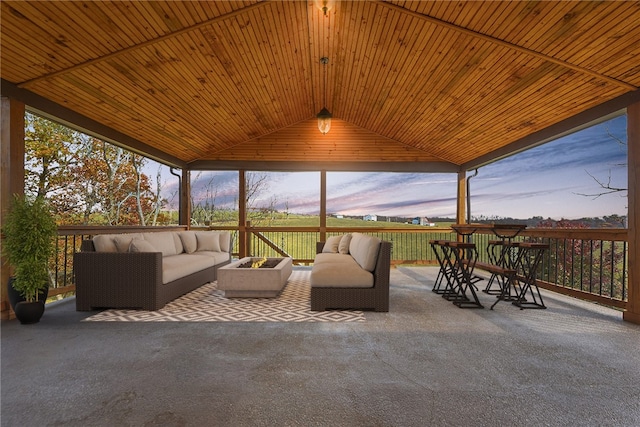 sunroom / solarium with a healthy amount of sunlight, vaulted ceiling, and wooden ceiling