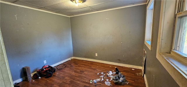 unfurnished room featuring a drop ceiling and dark hardwood / wood-style floors