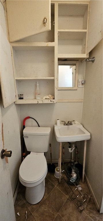 bathroom featuring tile patterned floors, toilet, and sink