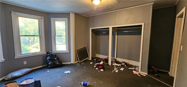 unfurnished bedroom featuring multiple windows