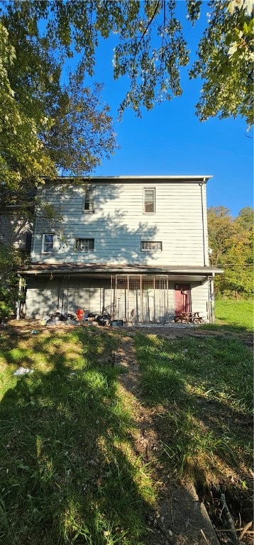 back of property featuring a yard