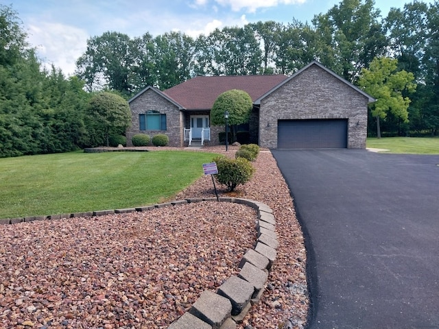 ranch-style home featuring a garage and a front lawn