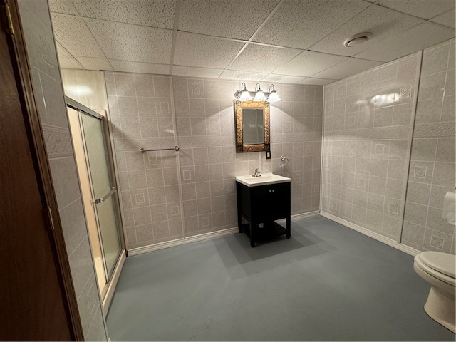 bathroom with concrete flooring, toilet, an enclosed shower, and tile walls