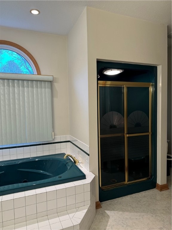 bathroom featuring a relaxing tiled tub