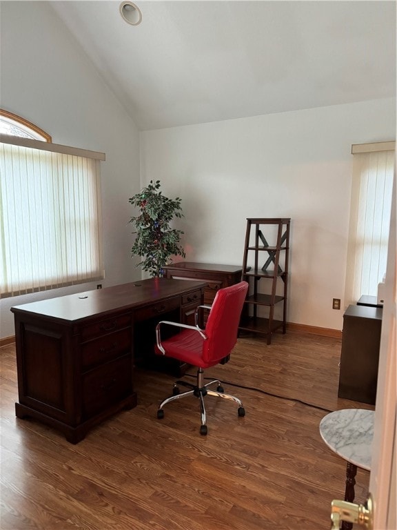 office area with hardwood / wood-style flooring, built in desk, and high vaulted ceiling