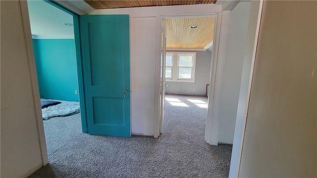 corridor featuring carpet flooring and wood ceiling