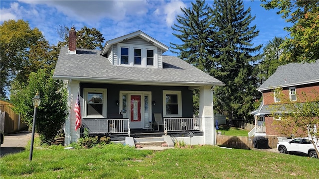 view of front of home with a front yard and a porch