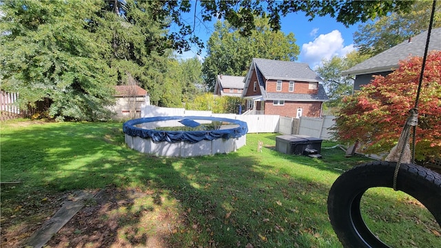 view of yard featuring a covered pool