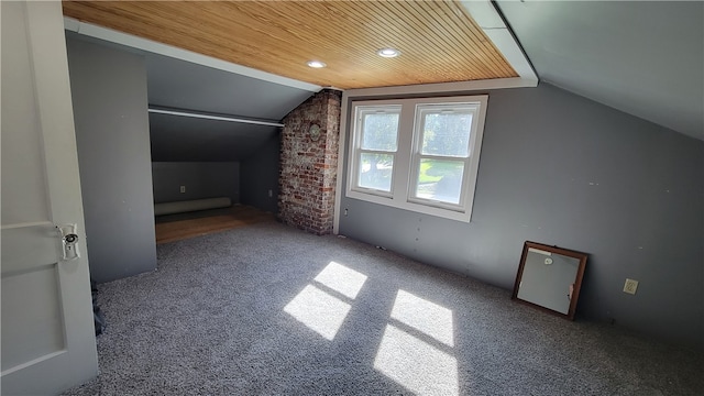 additional living space featuring wood ceiling, lofted ceiling, and carpet floors