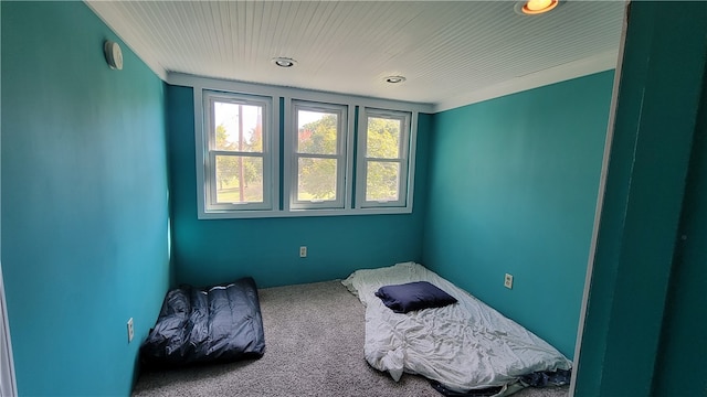 carpeted bedroom with ornamental molding