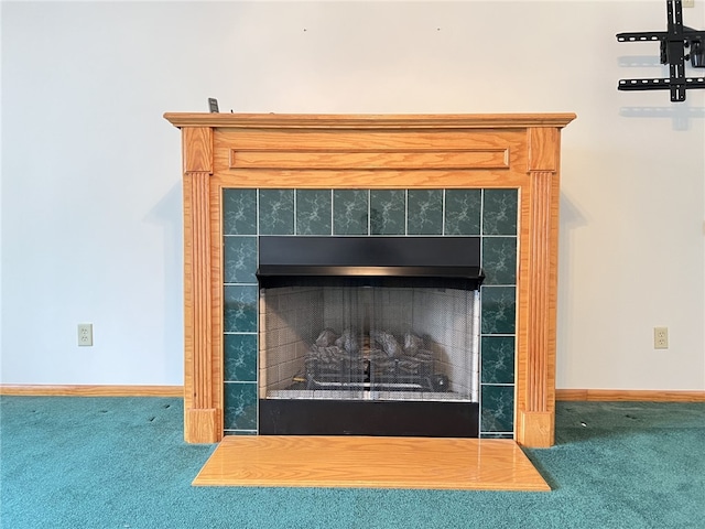 details featuring a tiled fireplace and carpet floors