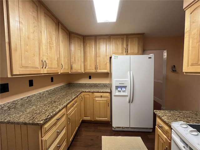 kitchen featuring light brown cabinets, white fridge with ice dispenser, dark stone countertops, and dark hardwood / wood-style flooring