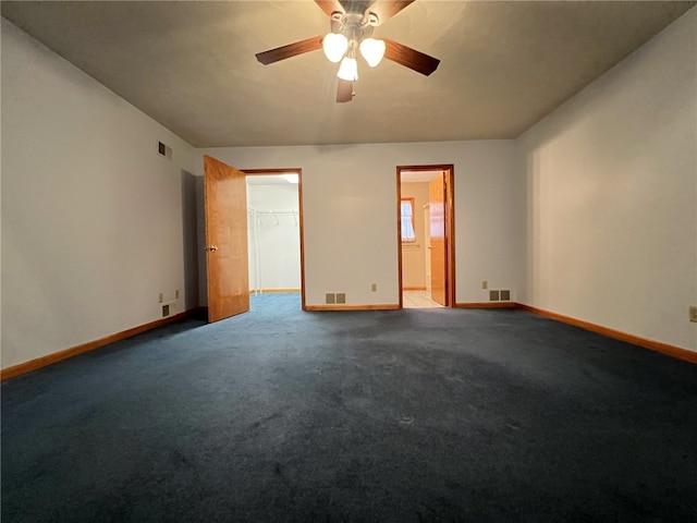 carpeted spare room with ceiling fan