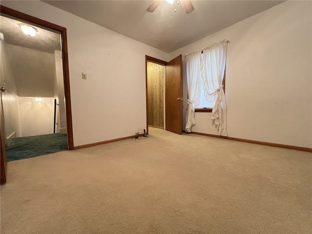 spare room with carpet flooring and ceiling fan