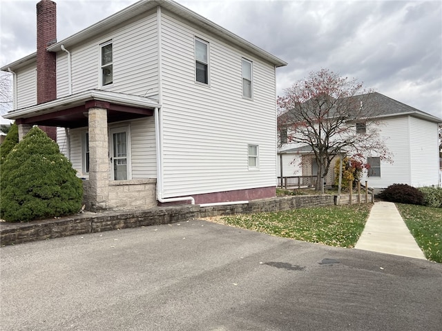 view of property exterior with covered porch