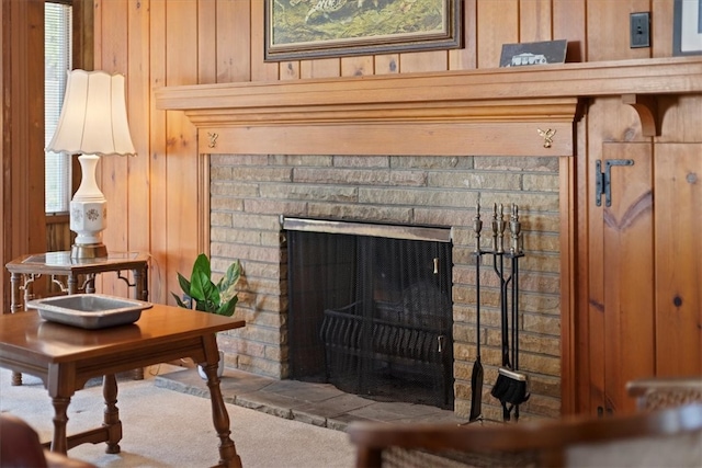 room details featuring wood walls and a fireplace