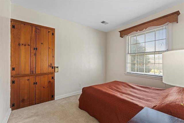 bedroom featuring light colored carpet