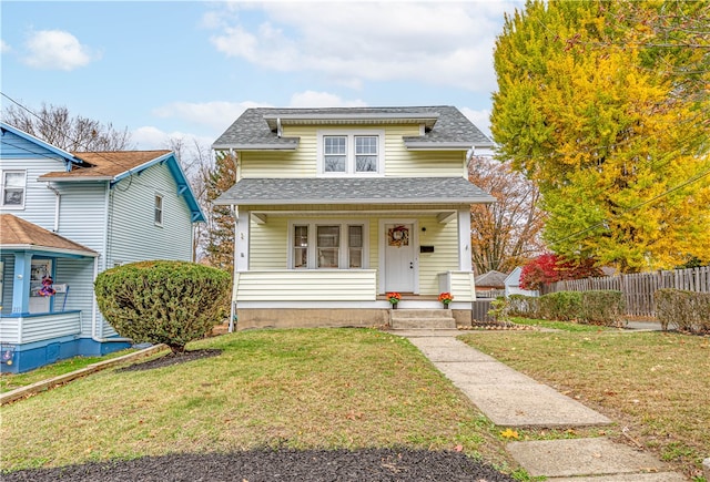 view of front facade with a front yard and a porch