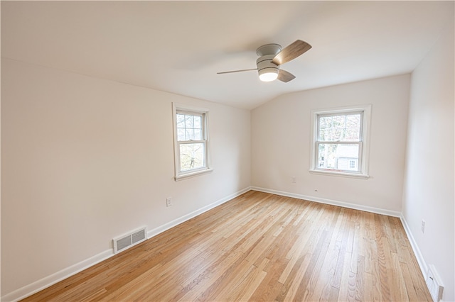 unfurnished room featuring light hardwood / wood-style floors, ceiling fan, a healthy amount of sunlight, and lofted ceiling