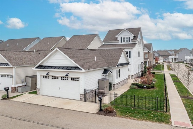 17 Carolina Ave, Oakmont, PA 15139 - view of front of property featuring stone siding, concrete driveway, a residential view, a standing seam roof, and roof with shingles