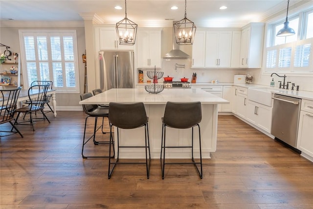 17 Carolina Ave, Oakmont, PA 15139 - kitchen with appliances with stainless steel finishes, ornamental molding, healthy amount of natural light, a kitchen breakfast bar, and a center island