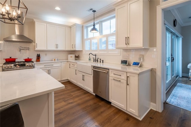 17 Carolina Ave, Oakmont, PA 15139 - kitchen with stainless steel appliances, crown molding, a chandelier, light countertops, and dark wood-style flooring