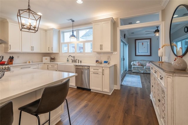 17 Carolina Ave, Oakmont, PA 15139 - kitchen with stainless steel appliances, ornamental molding, dark wood-style floors, decorative backsplash, and a ceiling fan