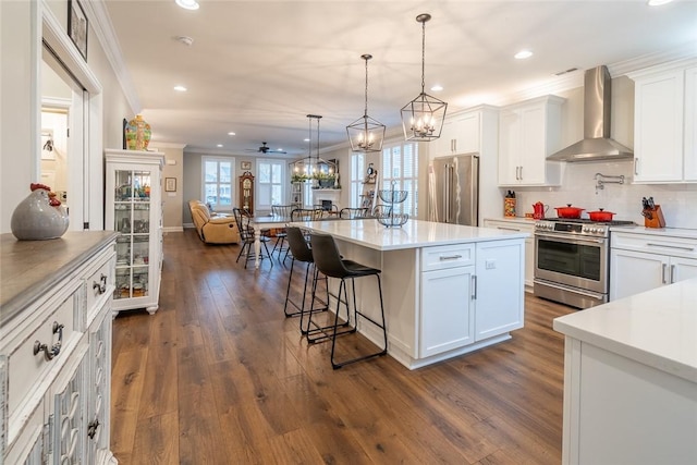 17 Carolina Ave, Oakmont, PA 15139 - kitchen with wall chimney range hood, high end appliances, ornamental molding, open floor plan, and recessed lighting