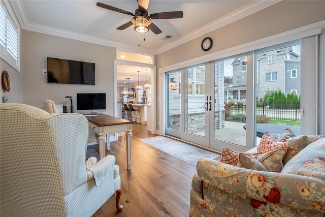 17 Carolina Ave, Oakmont, PA 15139 - living area featuring french doors, wood finished floors, crown molding, a ceiling fan, and a chandelier