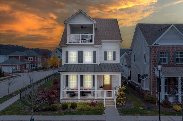 17 Carolina Ave, Oakmont, PA 15139 - view of front facade featuring a balcony, a porch, a standing seam roof, a ceiling fan, and a fenced backyard