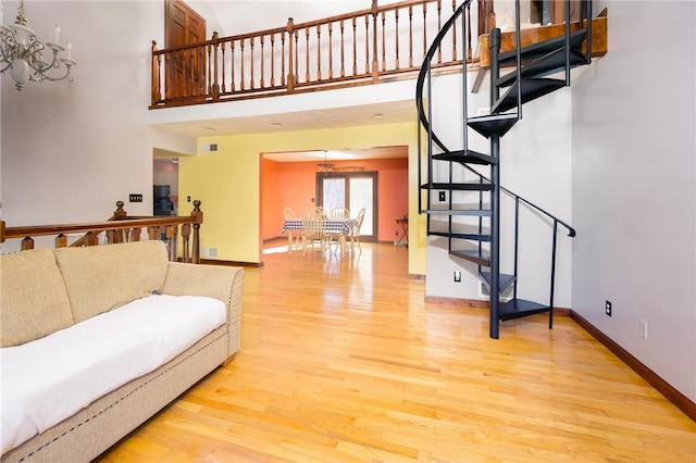 living room featuring light wood-type flooring and a chandelier