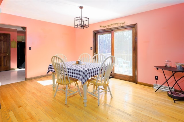 dining space featuring a chandelier and light hardwood / wood-style floors