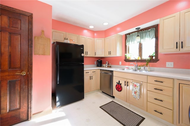 kitchen with light brown cabinets, black refrigerator, sink, and dishwasher