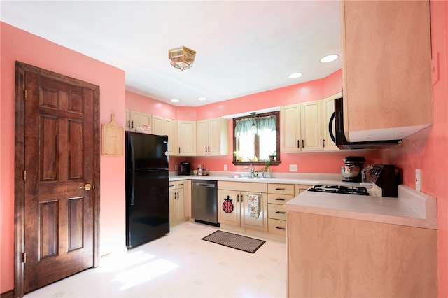 kitchen featuring black appliances, light brown cabinetry, and sink