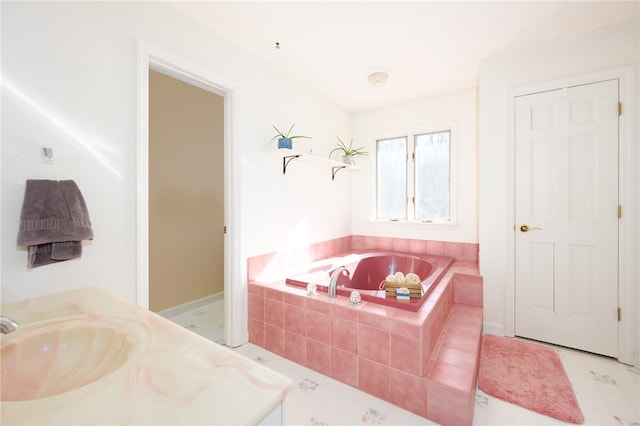 bathroom featuring vanity and a relaxing tiled tub