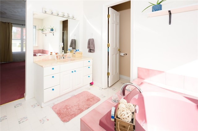 bathroom featuring a washtub and vanity