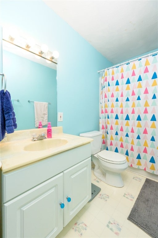 bathroom featuring vanity, curtained shower, and toilet