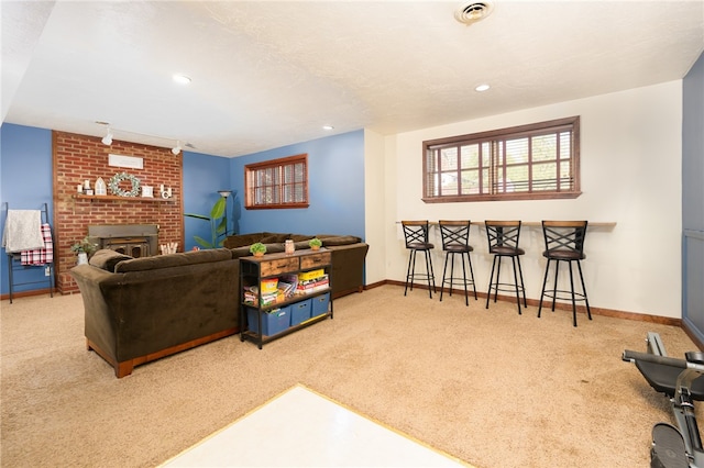 carpeted living room with bar and track lighting