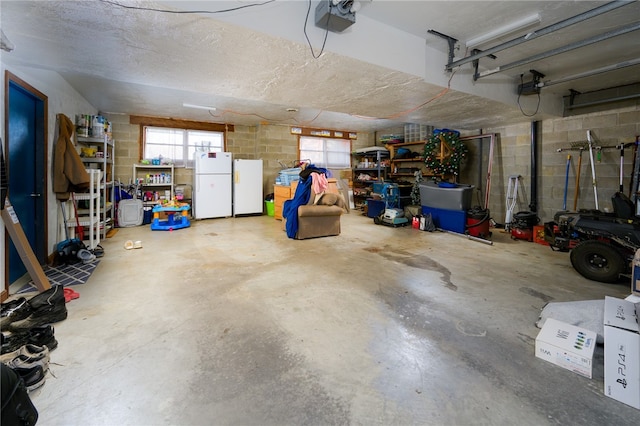 garage featuring a garage door opener and white refrigerator