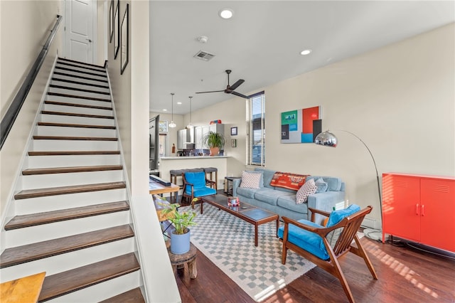 living room featuring dark hardwood / wood-style flooring and ceiling fan