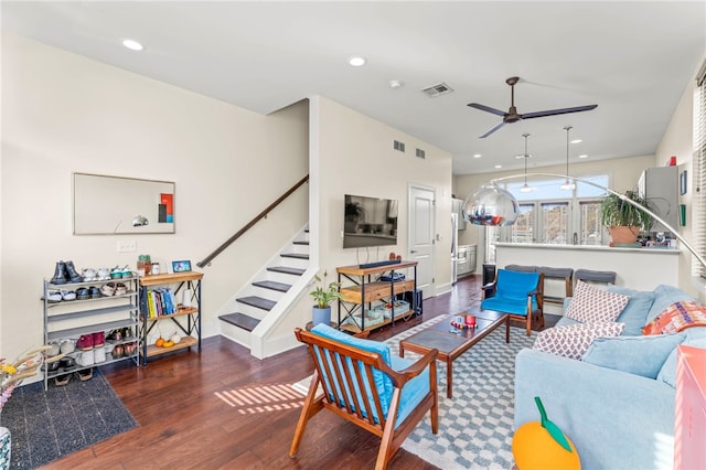 living room with ceiling fan and dark hardwood / wood-style flooring