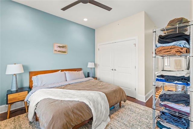 bedroom with hardwood / wood-style floors, ceiling fan, and a closet