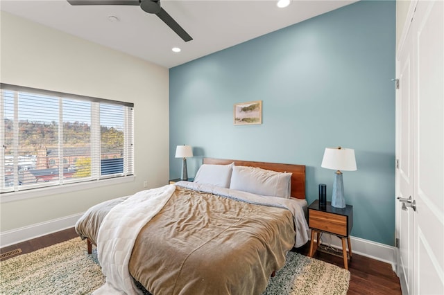 bedroom with ceiling fan and dark hardwood / wood-style floors