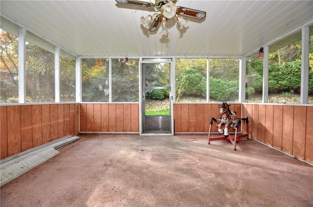 unfurnished sunroom with ceiling fan and plenty of natural light