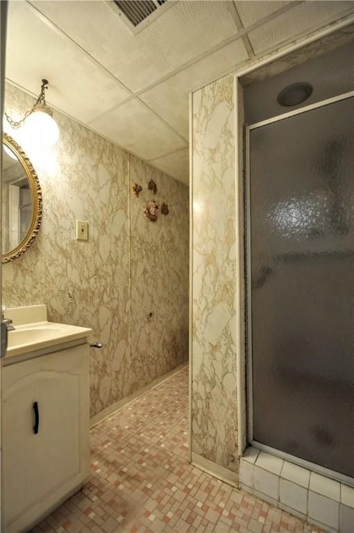 1011 Greenock Buena Vista Rd, Elizabeth Twp/Boro, PA 15135 - bathroom with a stall shower, vanity, baseboards, and wallpapered walls
